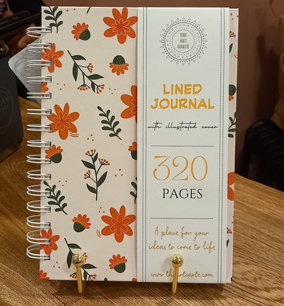 Floral notebook with lined pages on a wooden surface