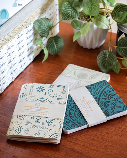 Aqua pocket sketchbook trio flat lay showing all three covers — The Art Carte