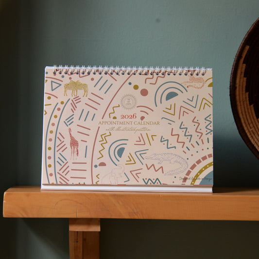 2026 appointment calendar with geometric pattern on a wooden surface against a dark green background